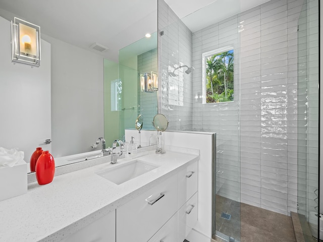 bathroom with walk in shower and vanity