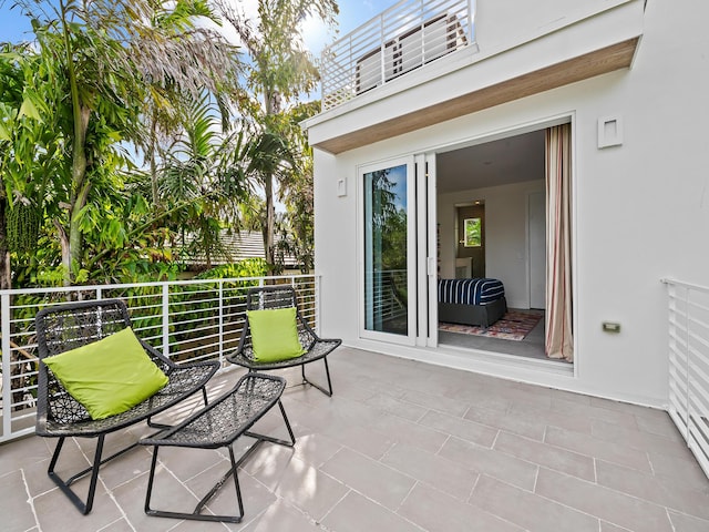 view of patio / terrace with baseboard heating and a balcony