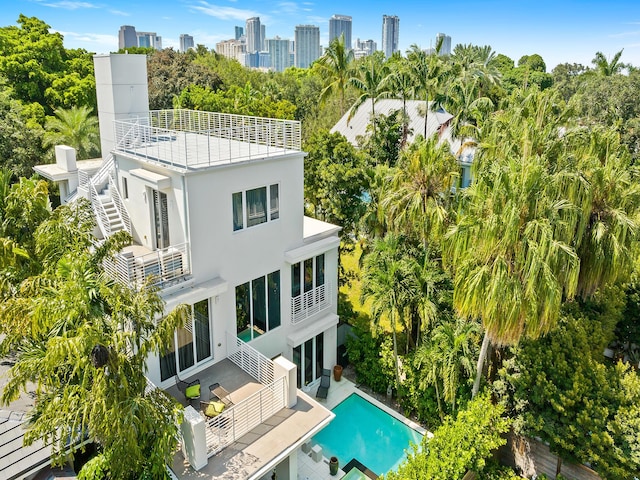 back of house featuring a balcony and a patio area