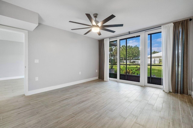 empty room with ceiling fan and light wood-type flooring