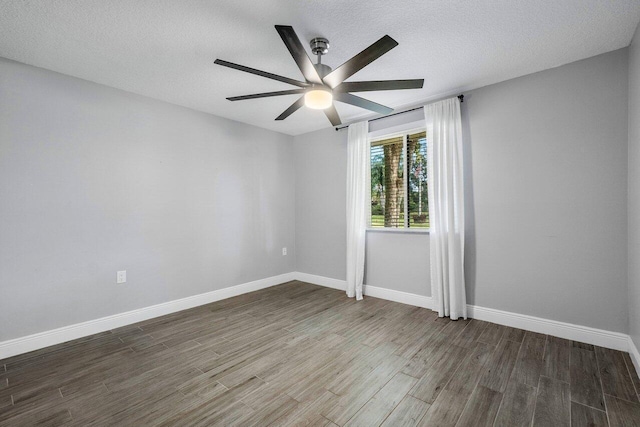 unfurnished room featuring ceiling fan, dark hardwood / wood-style flooring, and a textured ceiling