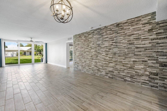 unfurnished living room with hardwood / wood-style floors, a chandelier, and a textured ceiling