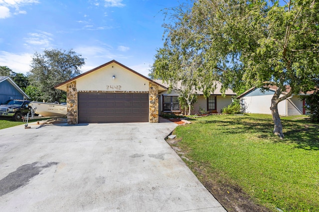 ranch-style home with a front yard and a garage