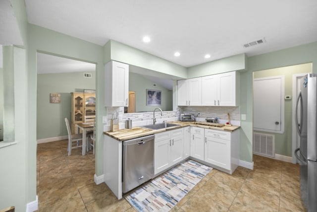 kitchen featuring sink, white cabinets, wooden counters, and appliances with stainless steel finishes