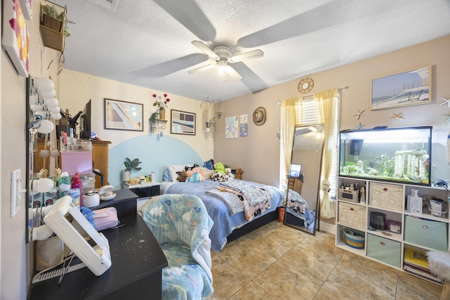 tiled bedroom with a textured ceiling and ceiling fan