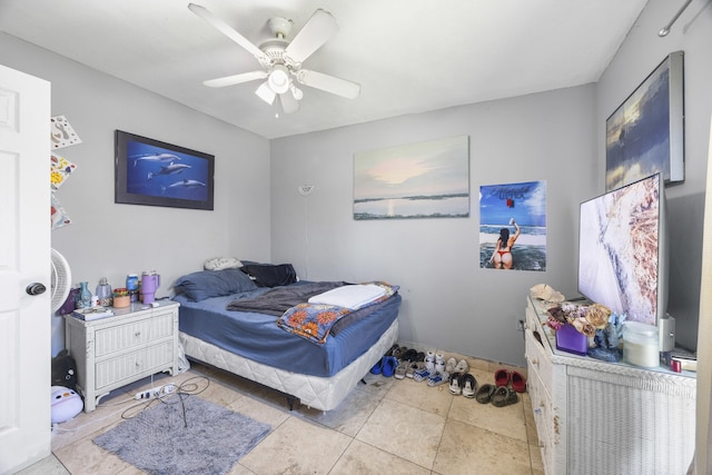 bedroom with ceiling fan and light tile patterned floors