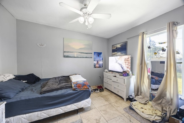 tiled bedroom featuring ceiling fan