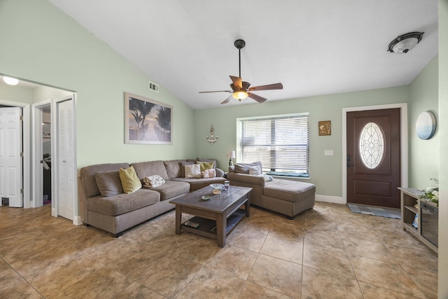 living room featuring ceiling fan, light tile patterned floors, and vaulted ceiling