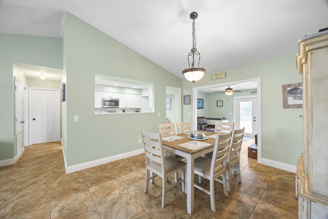 dining room featuring light tile patterned floors, ceiling fan, and lofted ceiling