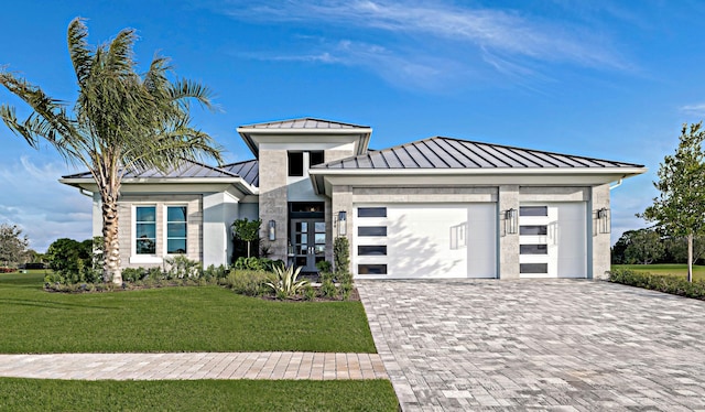 prairie-style home with french doors, a garage, and a front lawn