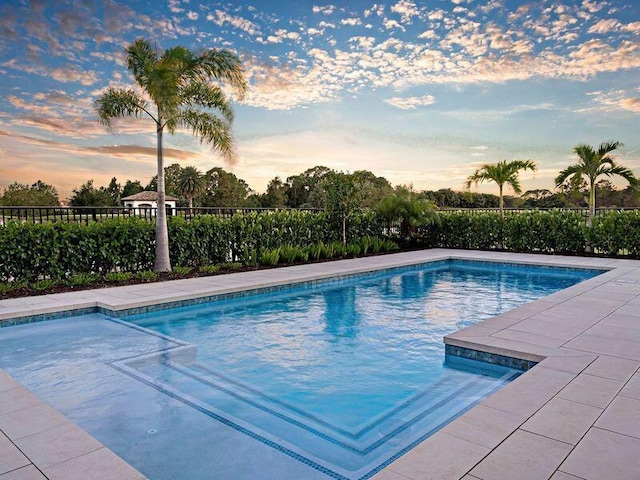 view of pool at dusk