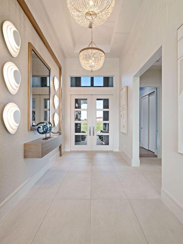 entrance foyer with french doors and an inviting chandelier