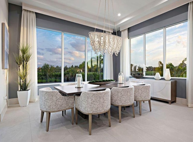 dining room featuring a notable chandelier and light tile patterned flooring