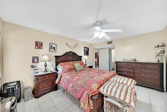 tiled bedroom featuring ceiling fan and a textured ceiling