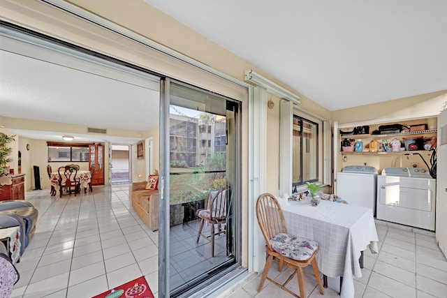 tiled dining room with washing machine and dryer