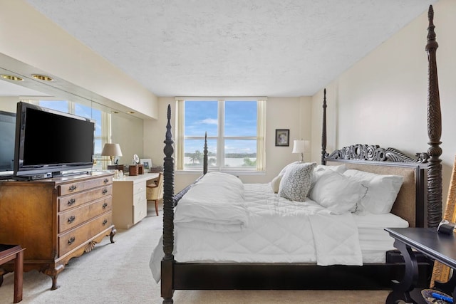 carpeted bedroom featuring a textured ceiling