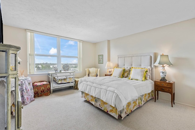 bedroom with carpet and a textured ceiling