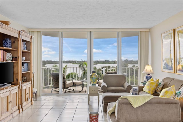 living room featuring a wealth of natural light, light tile patterned flooring, and a textured ceiling