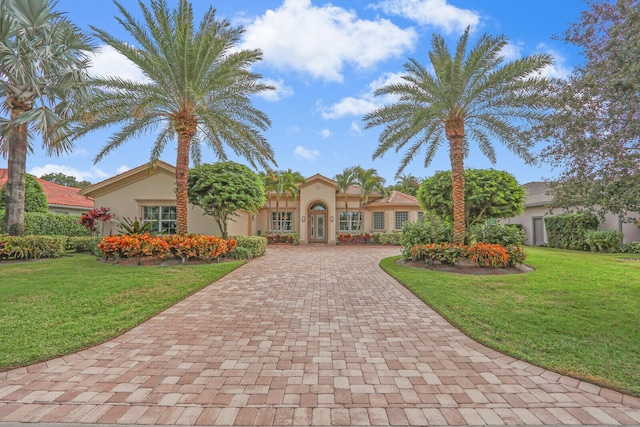 mediterranean / spanish-style home featuring a front lawn