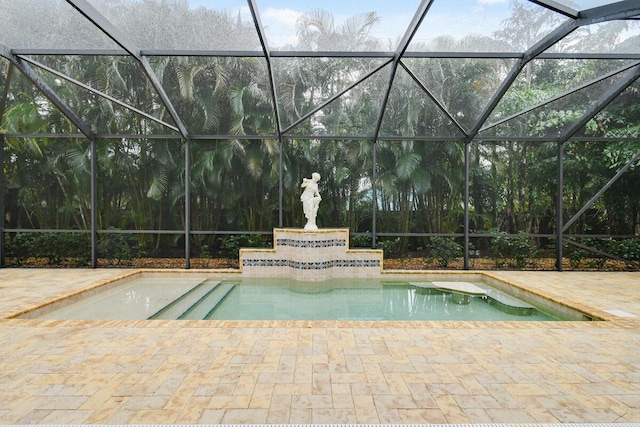 view of swimming pool featuring a lanai