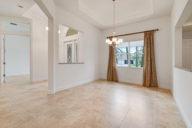 unfurnished room with a notable chandelier, crown molding, and a tray ceiling