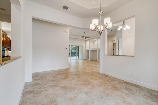 interior space with a raised ceiling and ceiling fan with notable chandelier