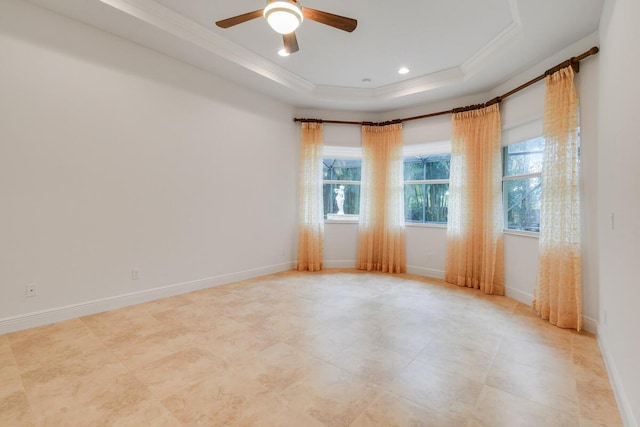 spare room featuring ceiling fan, crown molding, and a tray ceiling