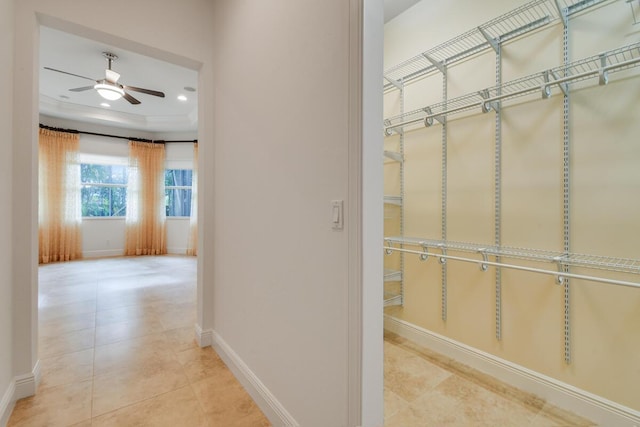 spacious closet featuring light tile patterned floors and ceiling fan