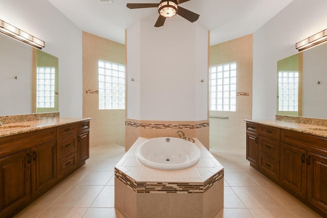 bathroom featuring tile patterned floors, a healthy amount of sunlight, and tiled tub