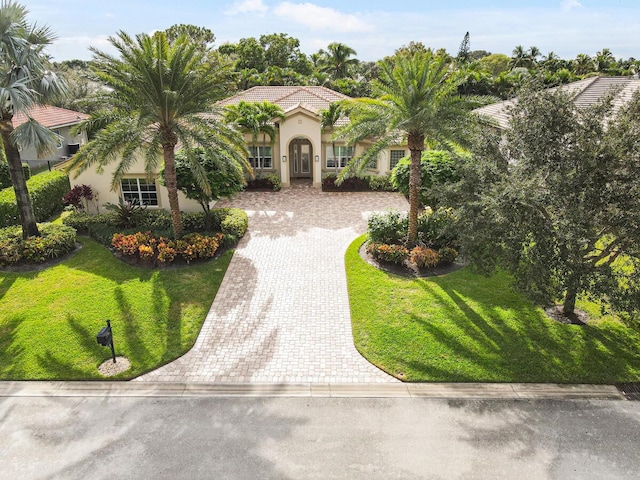 mediterranean / spanish home featuring a front yard