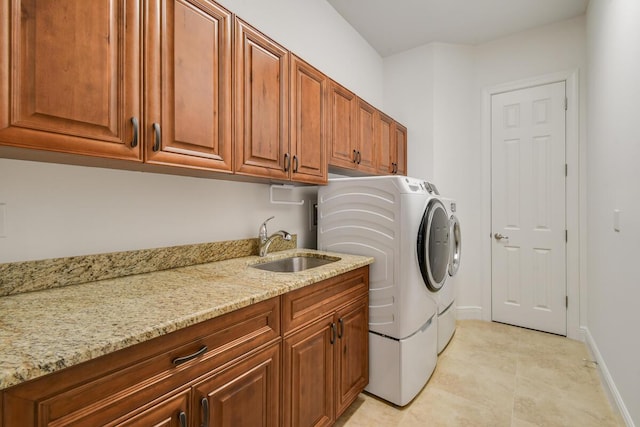 washroom featuring cabinets, separate washer and dryer, light tile patterned flooring, and sink