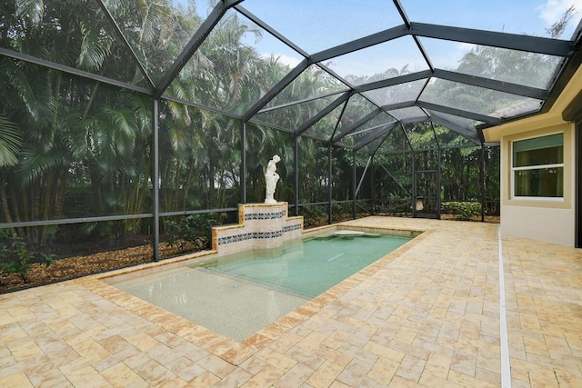 view of swimming pool with glass enclosure and a patio