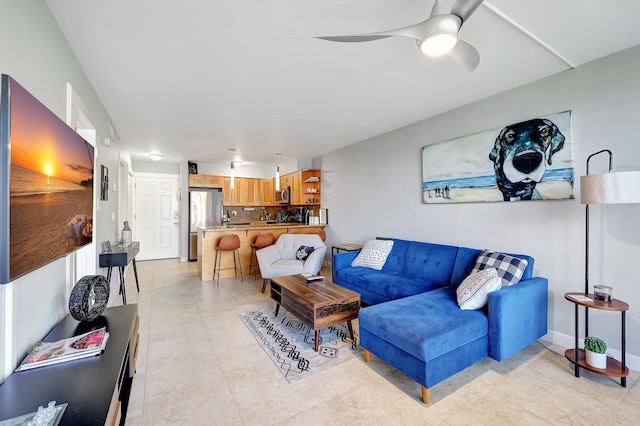 living room featuring ceiling fan and light tile patterned floors