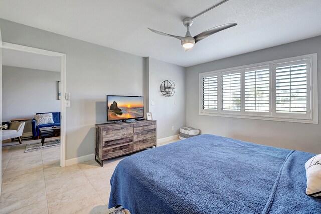 tiled bedroom with ceiling fan