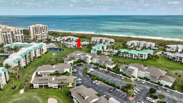 birds eye view of property with a beach view and a water view