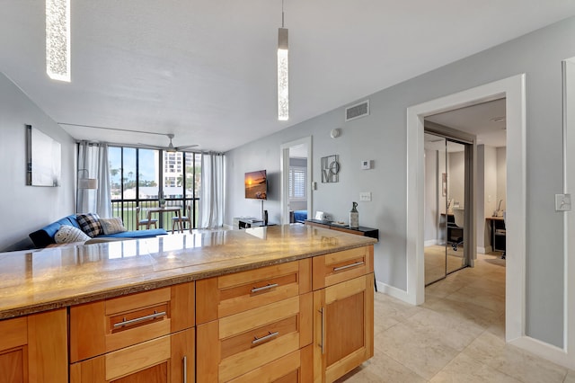 kitchen featuring pendant lighting and light tile patterned floors