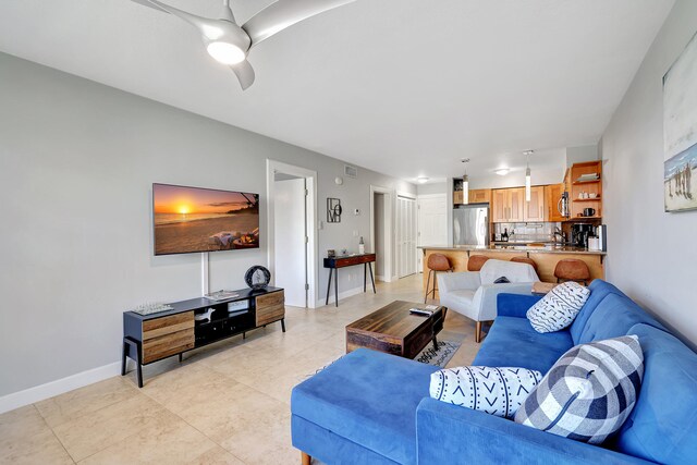 tiled living room featuring ceiling fan