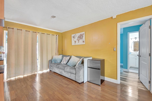 living room with hardwood / wood-style floors and a textured ceiling