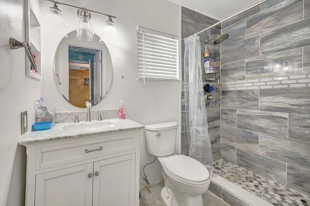 bathroom with a shower with curtain, vanity, and toilet