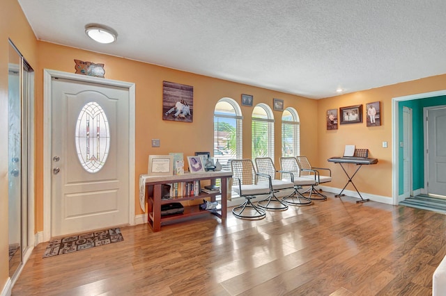 entryway featuring a textured ceiling and light wood-type flooring