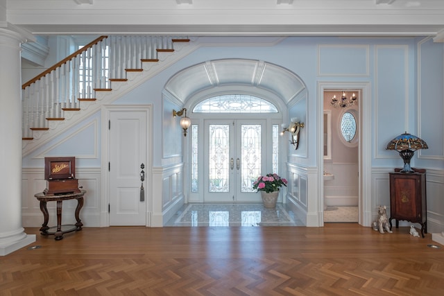 foyer entrance featuring parquet flooring and french doors