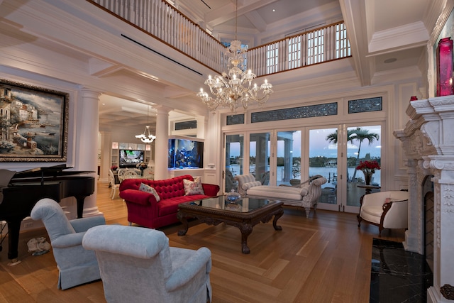 living room featuring hardwood / wood-style floors, a high end fireplace, coffered ceiling, french doors, and a water view