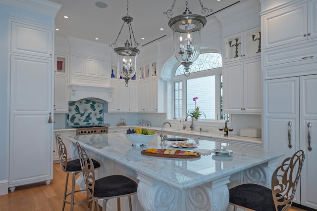 kitchen featuring white cabinetry, hanging light fixtures, and an inviting chandelier