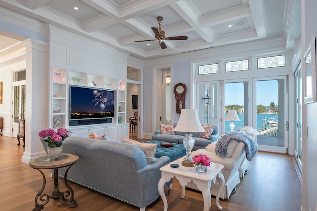 living room featuring beam ceiling, wood-type flooring, ornamental molding, and coffered ceiling