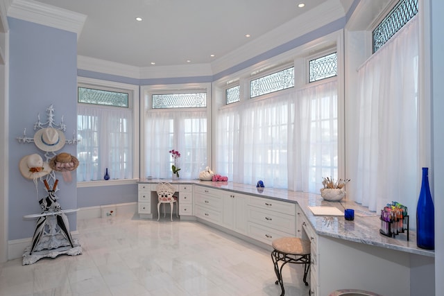 home office with a healthy amount of sunlight and crown molding