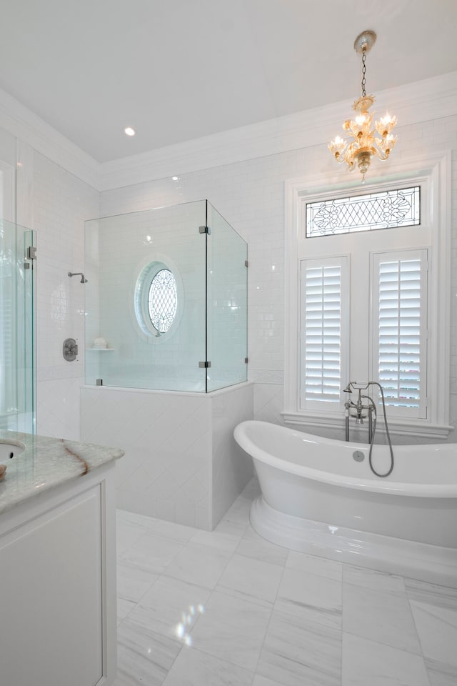 bathroom with vanity, ornamental molding, plus walk in shower, and a chandelier