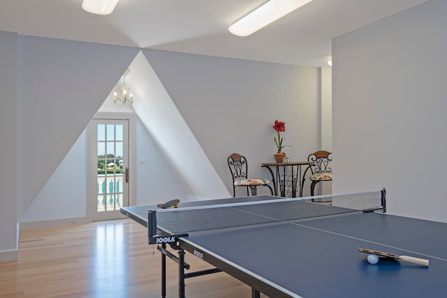 game room with a chandelier and light hardwood / wood-style floors