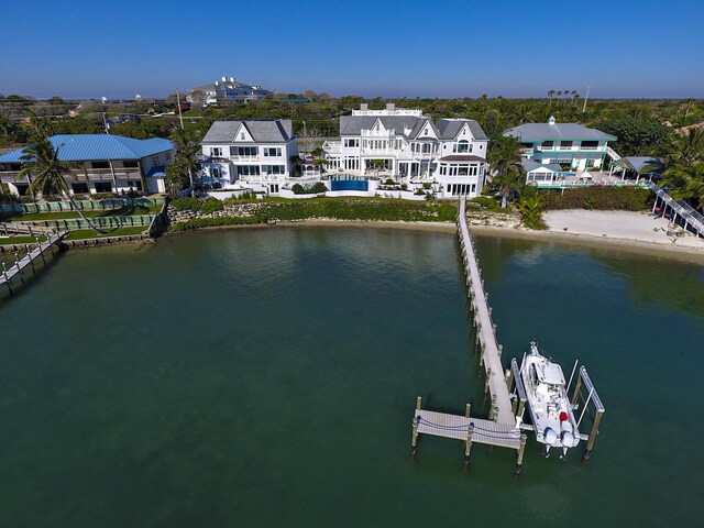 rear view of property featuring a water view and a balcony