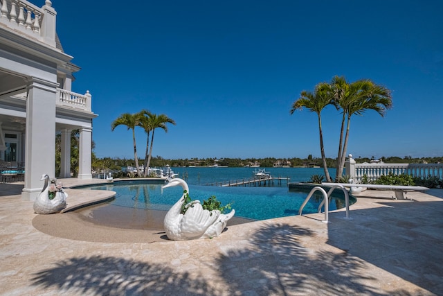 view of pool featuring a water view and a patio area