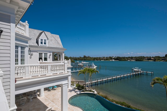 view of pool featuring a patio area and a water view